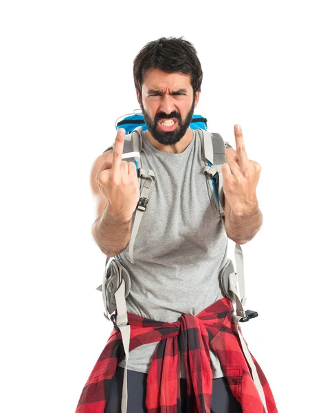 Backpacker making horn gesture over white background — 图库照片