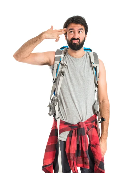 Backpacker making suicide gesture over white background — Stock fotografie