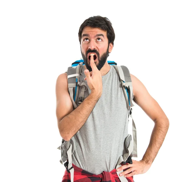 Backpacker making suicide gesture over white background — Stockfoto