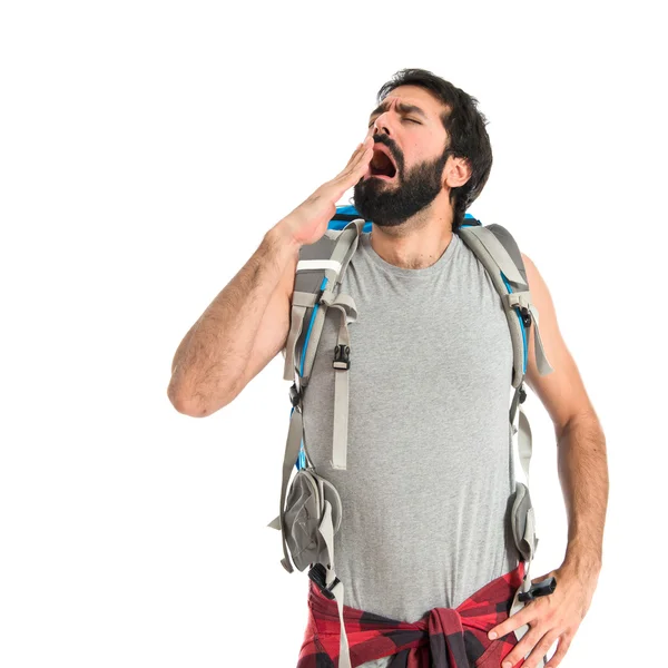 Backpacker yawning over isolated white background — 图库照片