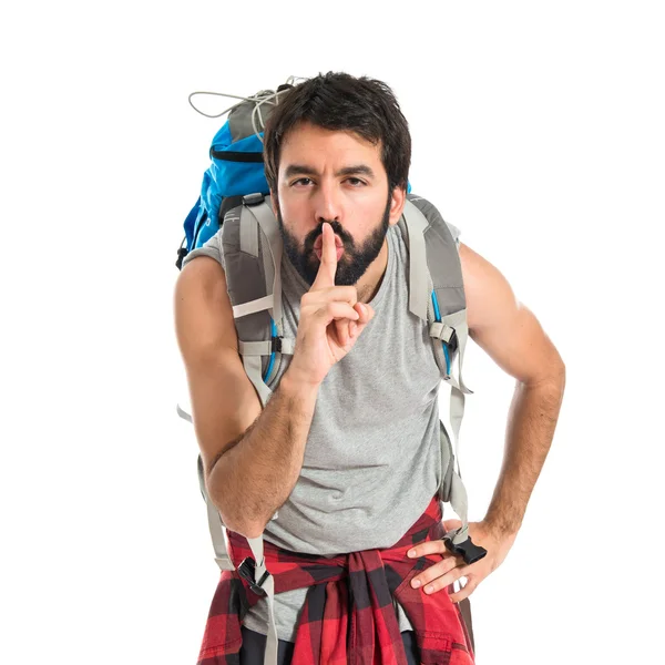 Backpacker making silence gesture over isolated white background — Stock Photo, Image