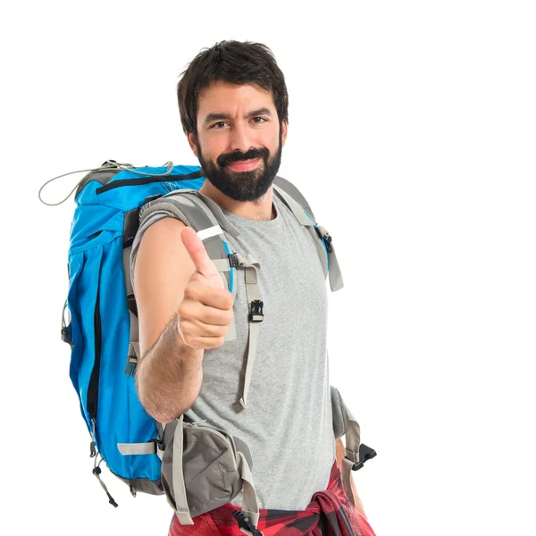 Beyaz arka plan üzerinde başparmak ile backpacker