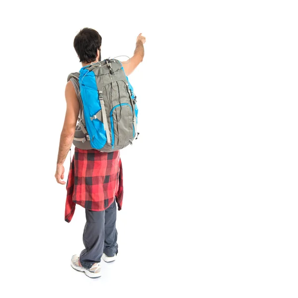 Backpacker δείχνοντας πίσω πάνω από το λευκό φόντο — Φωτογραφία Αρχείου