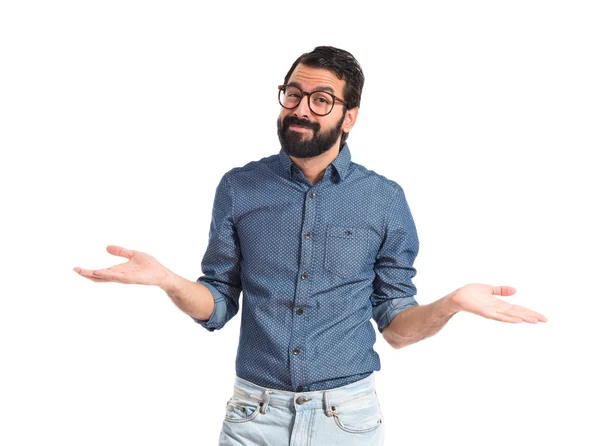 Young hipster man having doubts over white background — Stock Photo, Image