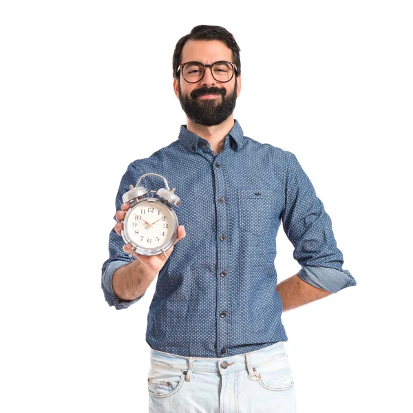 Young hipster man holding a clock — Stock Photo, Image