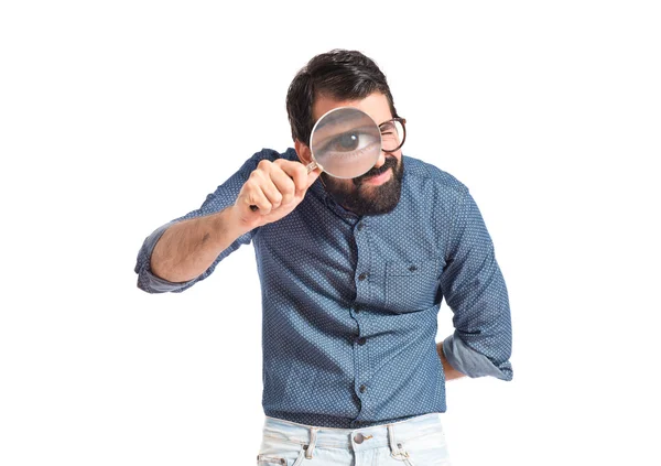 Young hipster man with magnifying glass — Stock Photo, Image