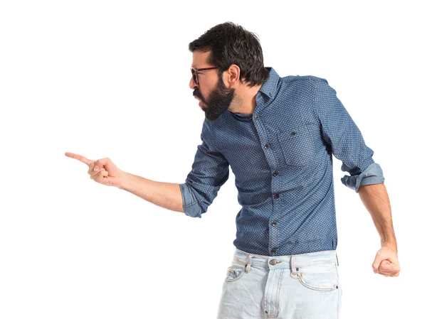 Young hipster man pointing and shouting — Stock Photo, Image