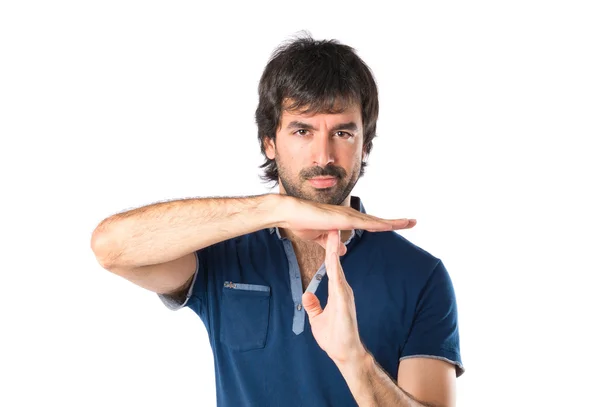Man making time out gesture over white background — Stock Photo, Image