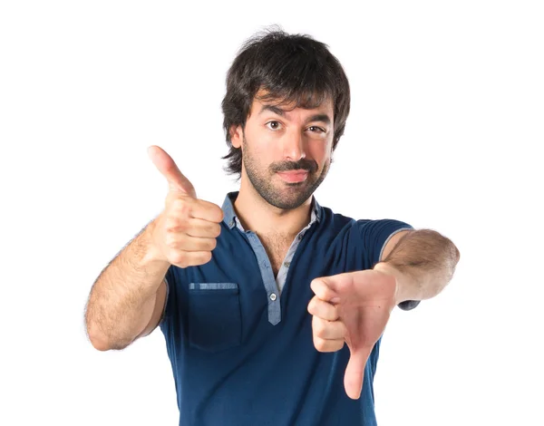 Man doing a bad signal over white background — Stock Photo, Image