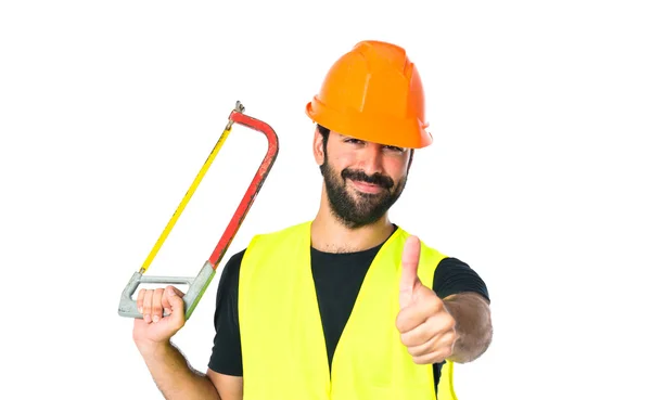 Handwerker mit Säge auf weißem Hintergrund — Stockfoto