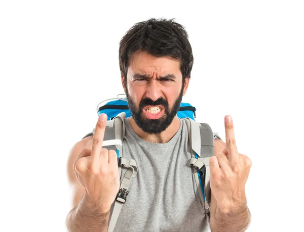 Backpacker making horn gesture over white background — 图库照片