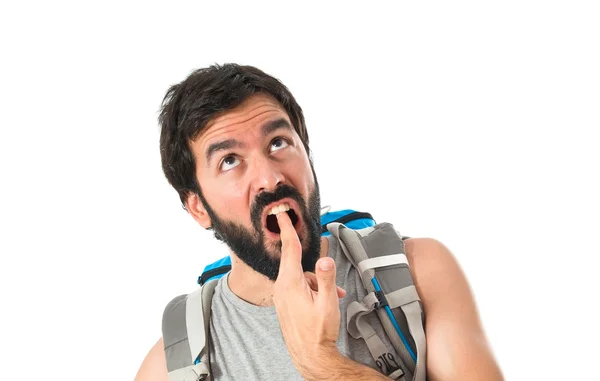 Backpacker making suicide gesture over white background — Stockfoto