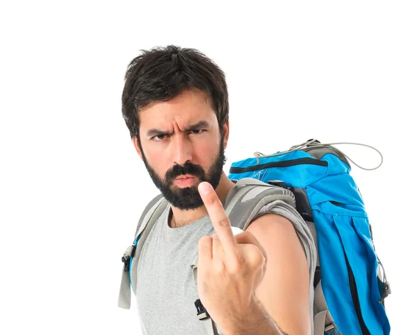 Backpacker making horn gesture over white background — Stockfoto