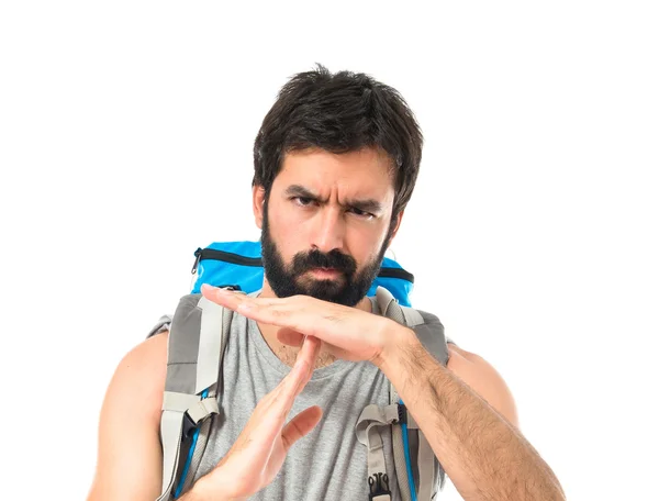 Backpacker making time out gesture over white background — ストック写真