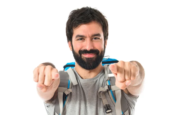 Backpacker pointing to the front over white background — Stock Photo, Image