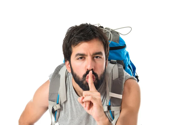 Sac à dos faisant geste de silence sur fond blanc isolé — Photo