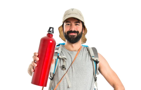 Backpacker drinking water over white background — Stock Photo, Image