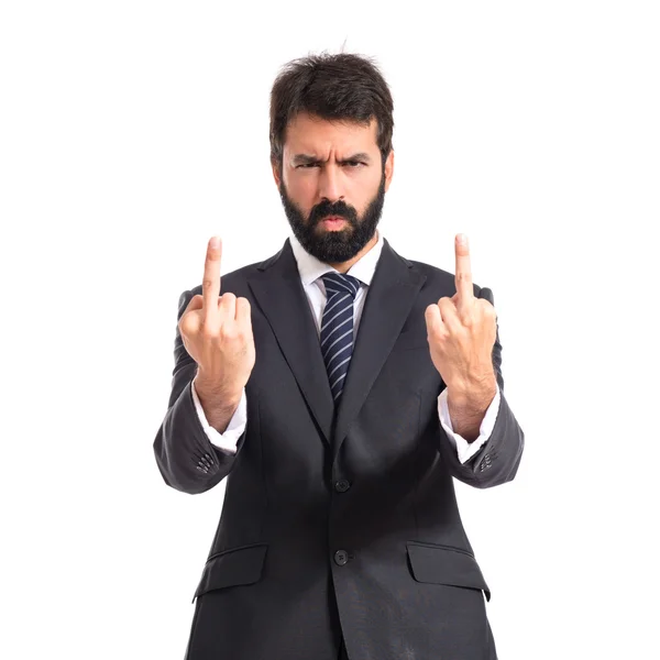 Businessman making horn gesture over white background — Stock Photo, Image