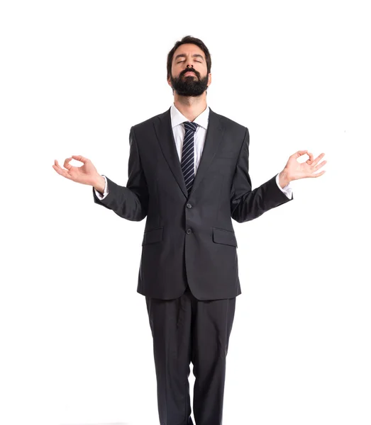 Businessman in zen position over white background — Stock Photo, Image