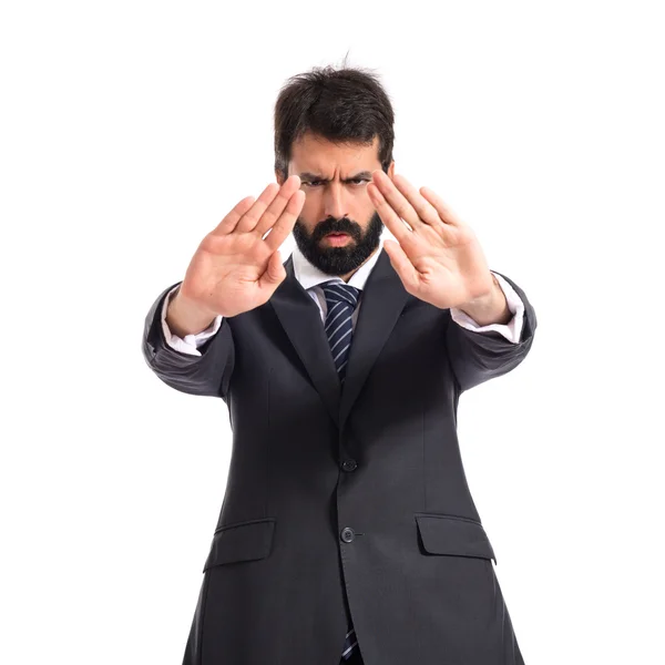 Businessman making stop sign over white background — Stock Photo, Image