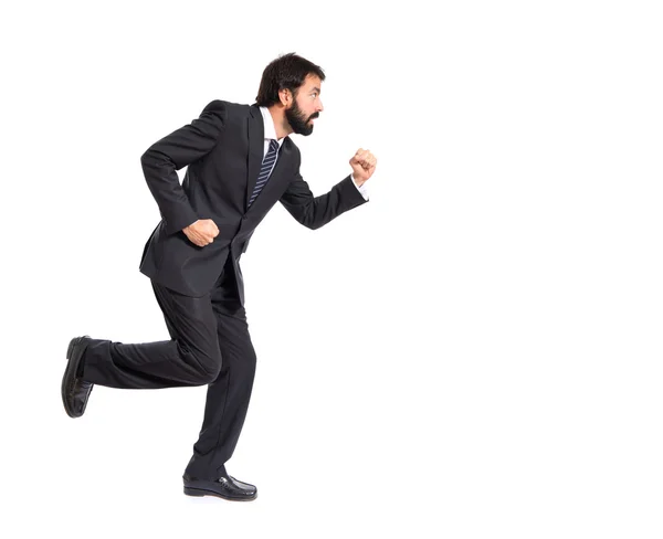 Businessman running fast over white background — Stock Photo, Image