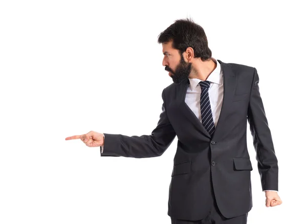 Businessman pointing and shouting over isolated white background — Stock Photo, Image