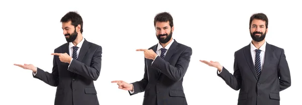 Businessman pointing to the lateral over white background — Stock Photo, Image