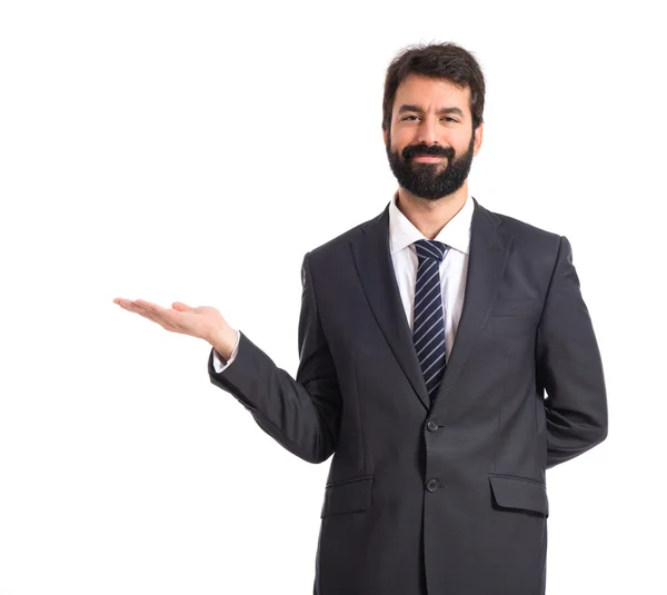 Businessman presenting something over isolated white background — Stock Photo, Image