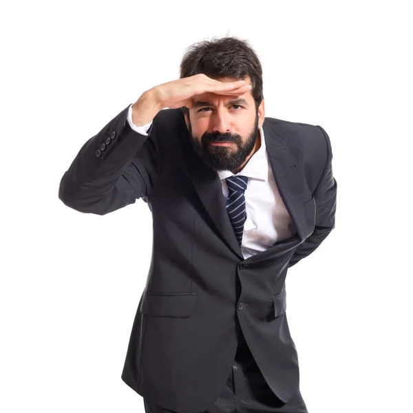 Empresario mostrando algo sobre fondo blanco — Foto de Stock