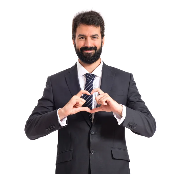 Empresario haciendo un corazón con sus manos sobre fondo blanco —  Fotos de Stock