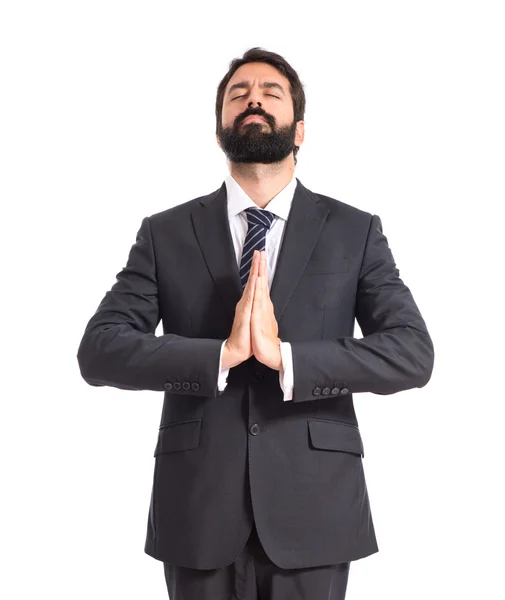 Businessman in zen position over white background — Stock Photo, Image