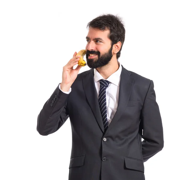 Empresario hablando por plátano sobre fondo blanco — Foto de Stock