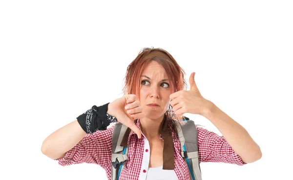 Backpacker making a good-bad sign over white background — 图库照片