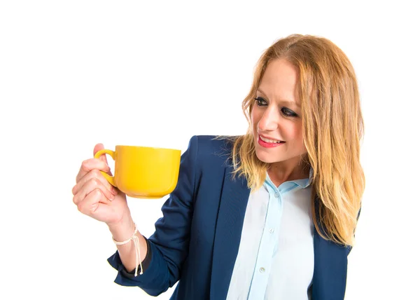 Blonde fille tenant une tasse de café sur fond blanc — Photo