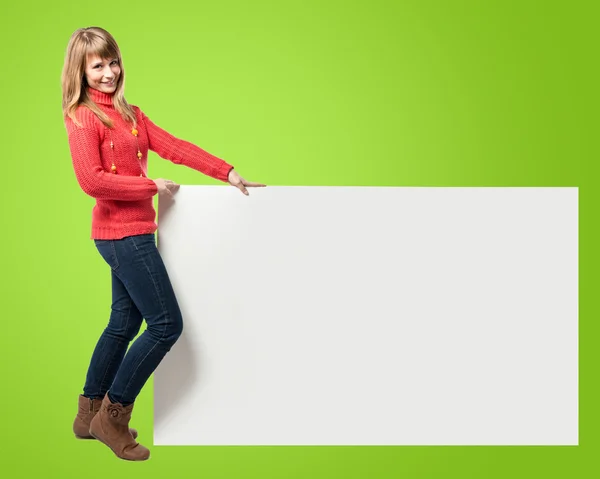 Woman with empty placard over green background — Stock Photo, Image