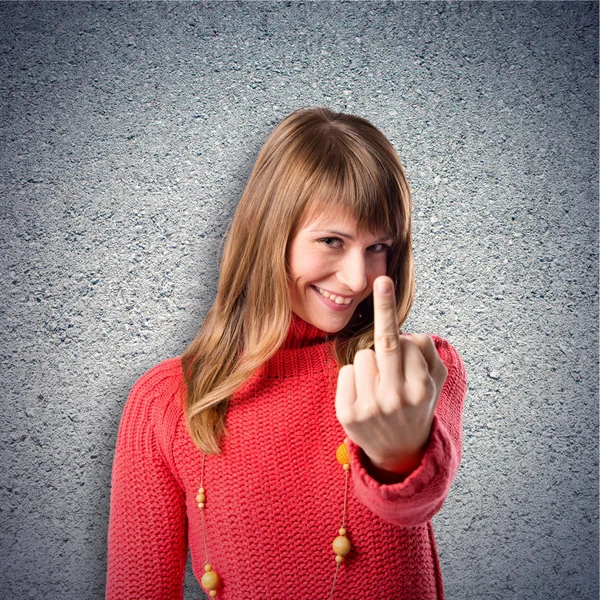 Girl making horn gesture over textured background — Stock Photo, Image