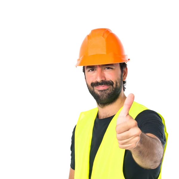 Workman with thumb up over white background Stock Picture