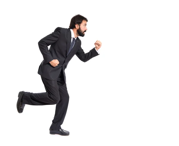 Businessman running fast over white background Royalty Free Stock Images