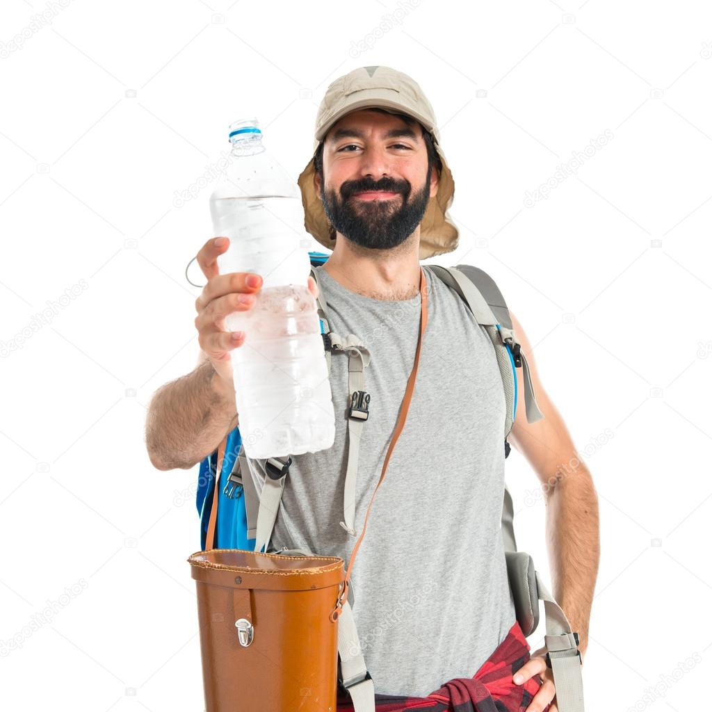 Backpacker drinking water over white background