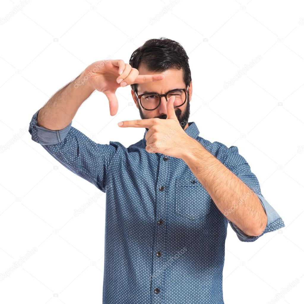 Young hipster man focusing with his fingers