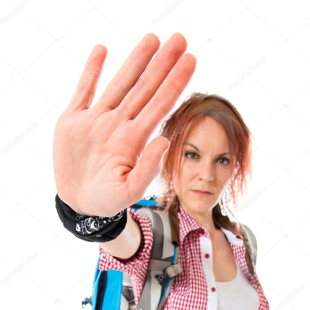 backpacker making stop sign over white background