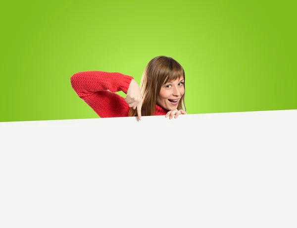 Woman with empty placard over green background — Stock Photo, Image