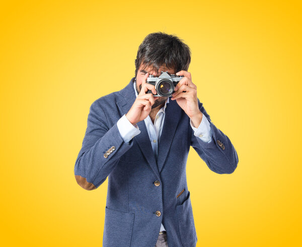 Man photographing over yellow background