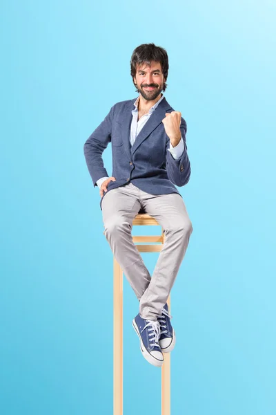 Lucky man over isolated blue background — Stock Photo, Image