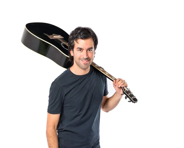Knappe man met gitaar op witte achtergrond — Stockfoto