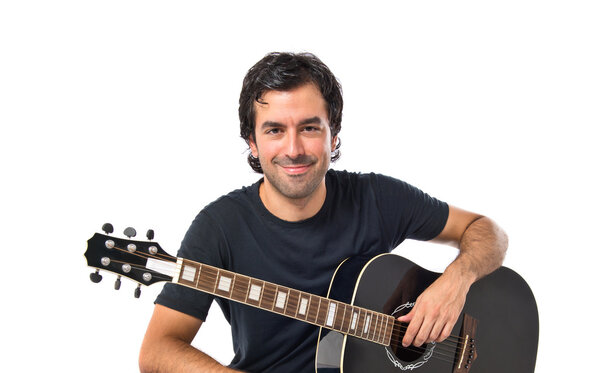 Handsome man with guitar over white background