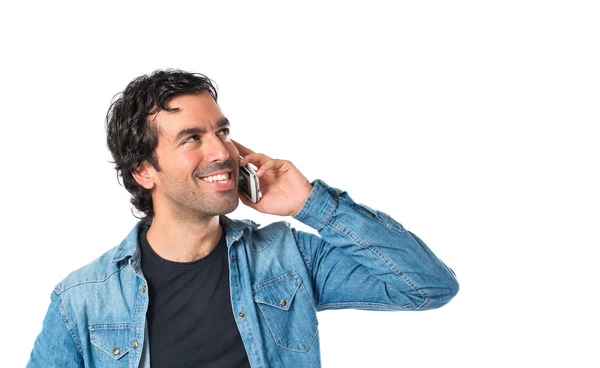 Handsome man talking to mobile over white background — Stock Photo, Image