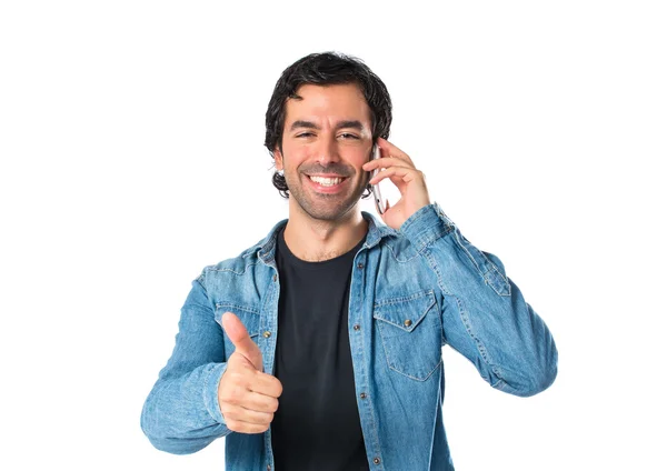 Handsome man talking to mobile over white background — Stock Photo, Image