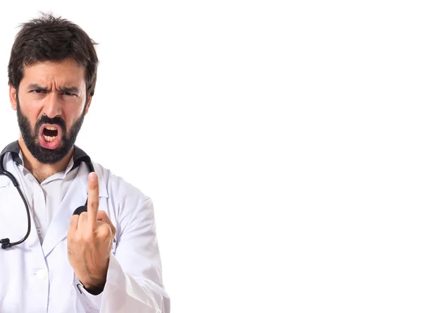 Doctor making horn gesture over white background — Stock Photo, Image