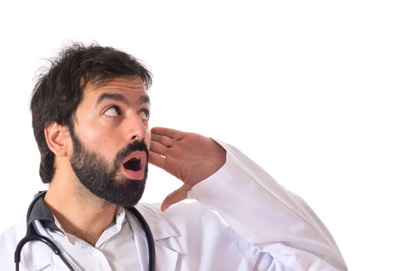 Doctor listening over isolated white background — Stock Photo, Image